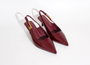 Pair of red slingback shoes on a white background