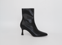 Black ankle boot on a light gray background