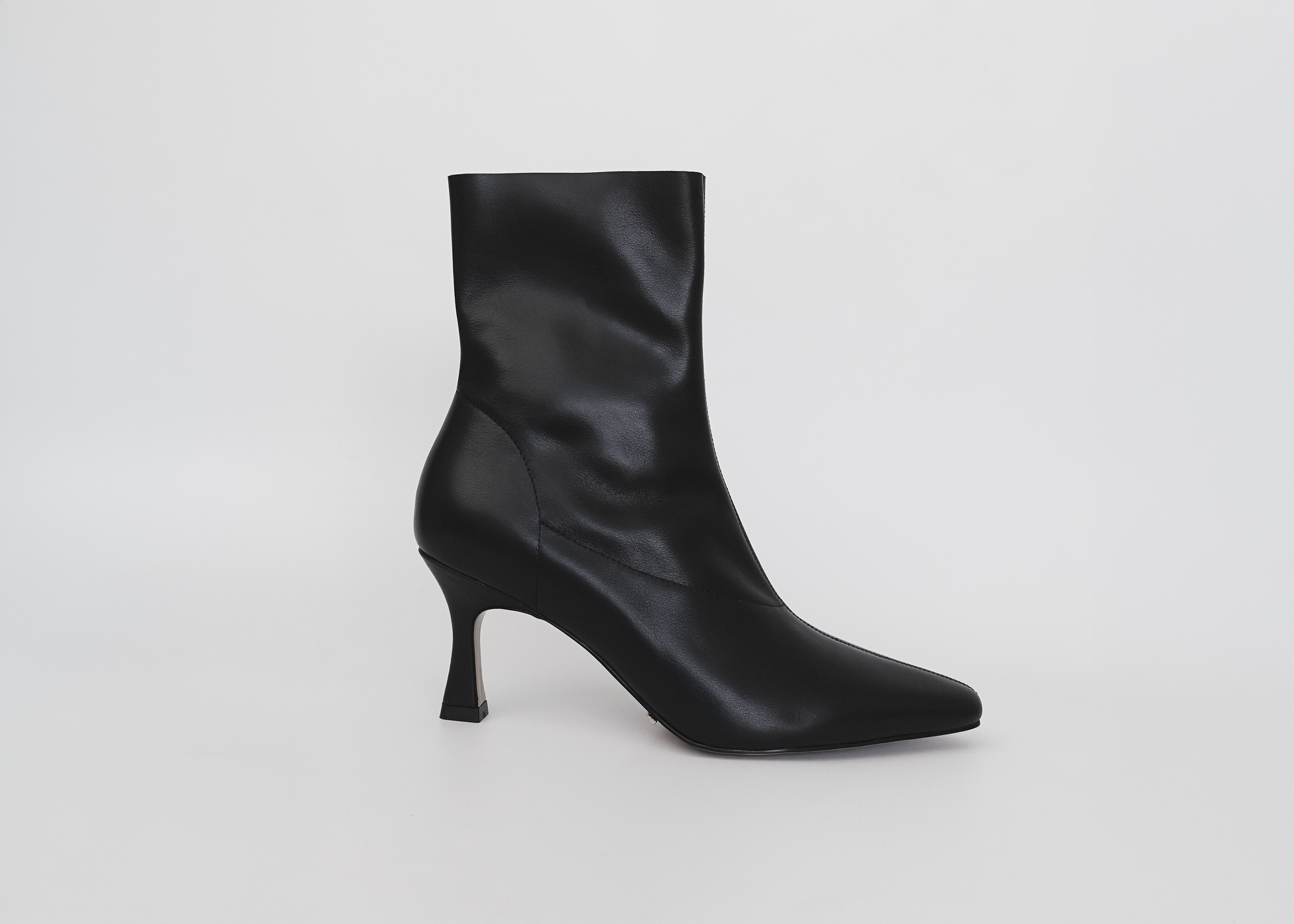 Black ankle boot on a light gray background